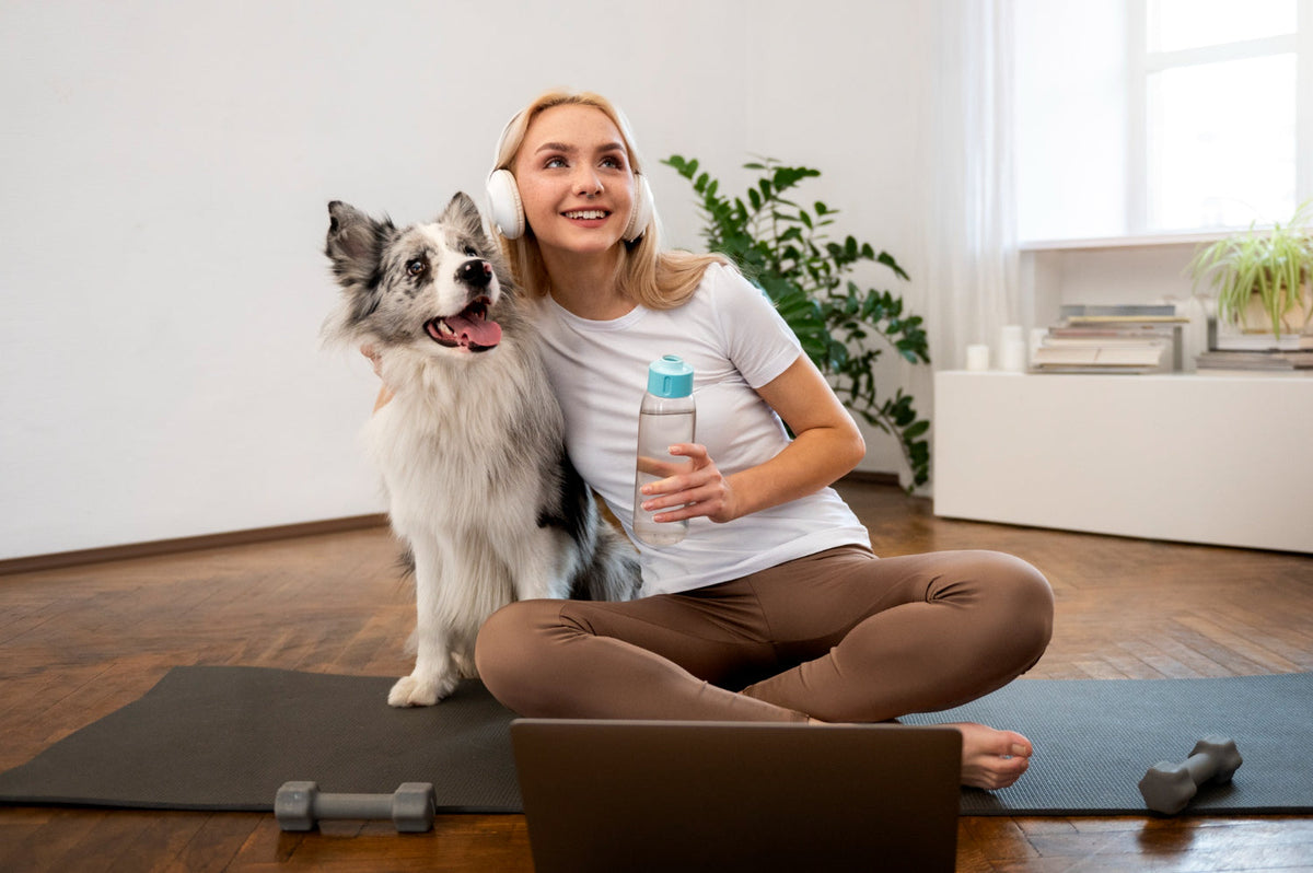 Person doing yoga accompanied by her dog